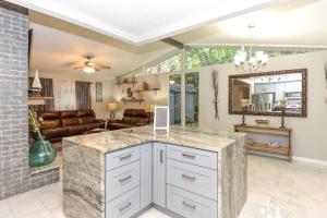 a kitchen with a counter and a living room at Tropical Hideaway in Port Orange