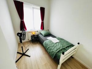 een kleine slaapkamer met een bed en een raam bij Ganha holiday house in Antwerpen