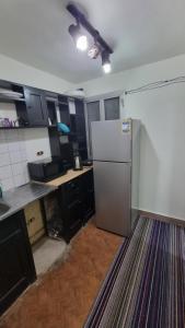 a kitchen with a refrigerator in the middle of it at Smouha studo apartment - families only in Alexandria