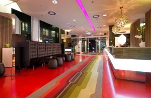 a lobby with a colorful floor in a building at Leonardo Hotel Berlin Mitte in Berlin