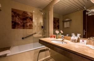 a bathroom with a sink and a shower at Leonardo Hotel Barcelona Gran Via in Barcelona
