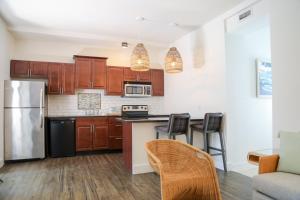 a kitchen with a refrigerator and a table with chairs at Fitch Lodge - Key West Historic Inns in Key West +15 photos