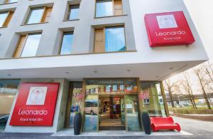 a building with a red chair in front of it at Leonardo Royal Hotel Ulm in Ulm