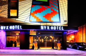 a myx hotel is lit up at night at NYX Hotel Mannheim by Leonardo Hotels in Mannheim