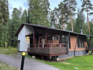 a house with a large porch on the side of it at Imatra Kylpyla Spa Entire Apartment in Imatra
