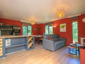 a living room with red walls and a couch at Witte Bungalow in Uden