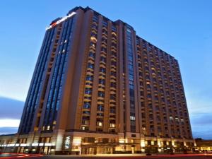 a large building with lights in front of it at Modena by Fraser Putuo Shanghai in Shanghai