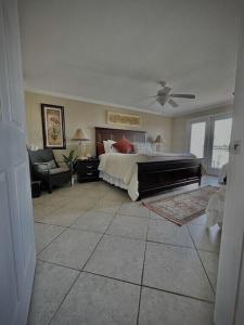 a large bedroom with a bed and a piano at Biloxi Beach Condo in Biloxi