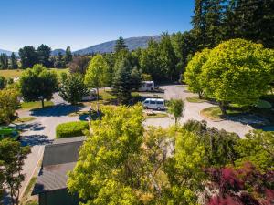 an aerial view of a parking lot with a rv parked at Wanaka Top 10 Holiday Park in Wanaka