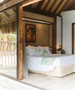 a bedroom with a large white bed in a room at Maitai Bora Bora in Bora Bora