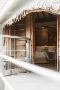 a bedroom with a bunk bed in a wooden house at Maitai Bora Bora in Bora Bora