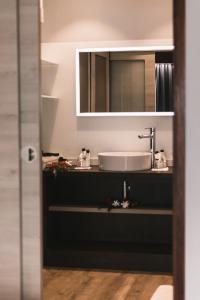 a bathroom with a sink and a mirror at Maitai Bora Bora in Bora Bora