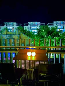 a table and chairs on a balcony at night at Awin swiss garden residence in Kuantan