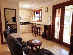 a living room with a couch and a table at Amamoor Lodge in Amamoor