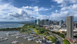 a city with a harbor with boats in the water at Spacious Studio w/ Parking, beach/mall/park in Honolulu