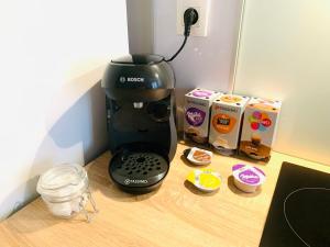 a coffee maker sitting on top of a wooden counter at Thuir, Charmante Maison T2 Climatisée in Thuir