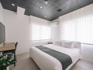 Postel nebo postele na pokoji v ubytování INFINITY HOTEL -jicchaku-