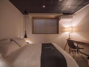 Postel nebo postele na pokoji v ubytování INFINITY HOTEL -jicchaku-