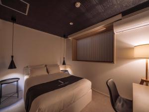 Postel nebo postele na pokoji v ubytování INFINITY HOTEL -jicchaku-