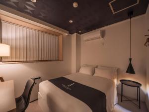 Postel nebo postele na pokoji v ubytování INFINITY HOTEL -jicchaku-