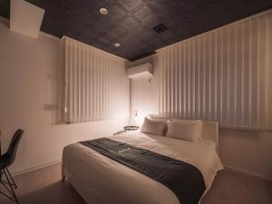 Postel nebo postele na pokoji v ubytování INFINITY HOTEL -jicchaku-
