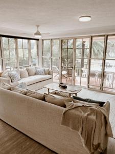 a living room with a couch and a table at Sea Breeze on Main Beach in Byron Bay