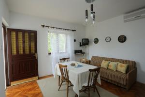 a living room with a table and a couch at Apartments with parking space Splitska, Brac - 15197 in Splitska