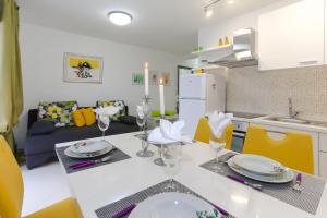 Una cocina y una sala de estar con mesa y sillas. en Apartments by the sea Tribunj, Vodice - 15233, en Tribunj
