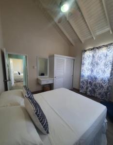 a bedroom with a large white bed and a window at Quiet Country Living in Saint George