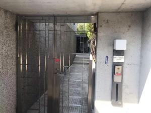 an entrance to a building with a revolving door at BRUCE Luxury House in Izumi-Sano
