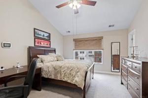 a bedroom with a bed and a desk and a ceiling fan at Comfortable Townhouse - Short Stroll to Notre Dame in South Bend