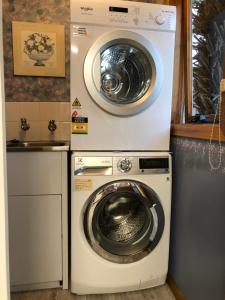 a washing machine and a dryer in a kitchen at Recreation Cottage in Kingston Beach
