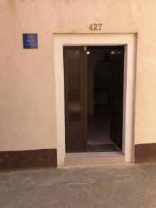 an open door of a building with the number at Apartments by the sea Susak, Losinj - 14713 in Susak