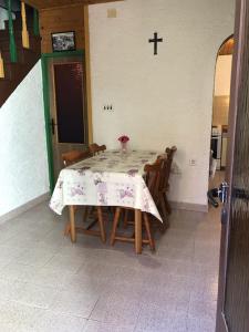 a dining room table with a cross on the wall at Apartments by the sea Susak, Losinj - 14713 in Susak