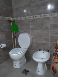 a bathroom with a toilet and a sink at Anexo Apart Ma y Cris II. Nuevo sector. 1°piso in Termas de Río Hondo