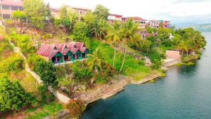 an island with houses on the side of a river at Mario Lakeside Apartments in Tuk Tuk