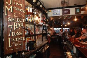 a bar with a lot of alcohol on the wall at Jim McGee's in Wexford