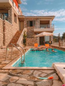 two people in a swimming pool in a house at Lavender House 1 - Agios Nikitas in Agios Nikitas