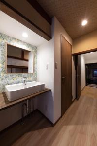 a bathroom with a sink and a mirror at 風早邸海音 kazahayatei mion in Hōjō +94 photos
