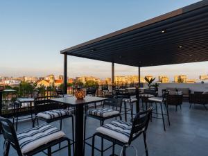 a restaurant with tables and chairs on a roof at Armonta Residences by BeCyprus in Limassol