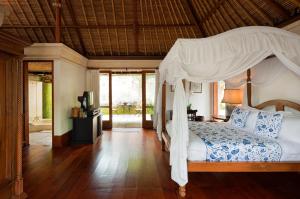 a bedroom with a bed with a canopy at COMO Shambhala Estate in Payangan