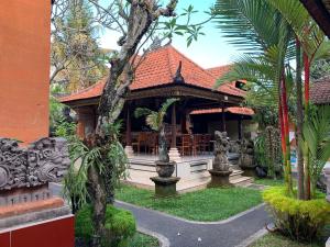 a house with a pavilion in a garden at Merthayasa Bungalow 2 in Ubud