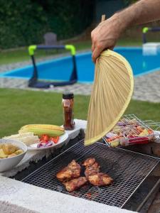 a person is cooking food on a grill at Villa Teratai 878 @ A'Famosa Resort in Kampong Alor Gajah +10 photos