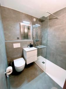 een badkamer met een toilet, een wastafel en een douche bij Apartment Del Sol Elysée 4 Crans Montana Switzerland in Crans-Montana