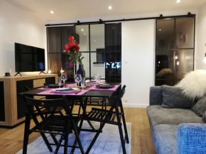 a dining room table and chairs in a living room at Le Week-End 3 étoiles, plein centre ville in La Clusaz +12 photos