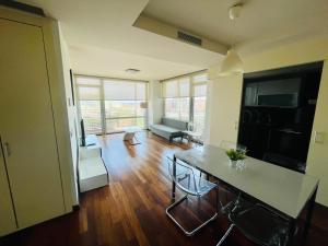 a living room with a table and a couch at Forum de Barcelona Sea View Apartment with Garage Parking in Sant Adria de Besos