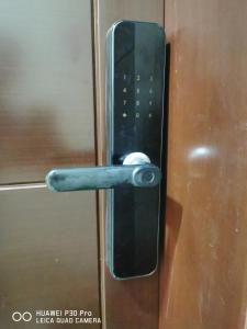 a metal door handle on a wooden door at Amazing 2BR pent house flat with mountain view in Muscat