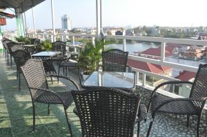 a group of chairs and tables on a balcony at Rose Hotel in Hai Phong