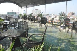 a row of chairs and tables on a patio at Rose Hotel in Hai Phong