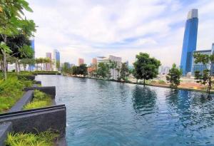 a river in a city with tall buildings at Lucky Continew Residence 1 Bedroom - TRX KL in Kuala Lumpur